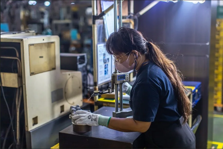 Skilled technician working on high-precision mold finishing at Siam Inter Mold factory